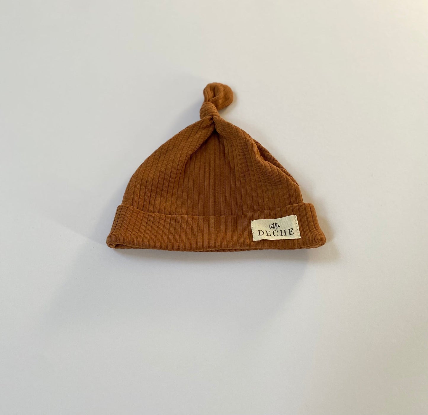 Organic Ribbed Top Knot Beanie Rust